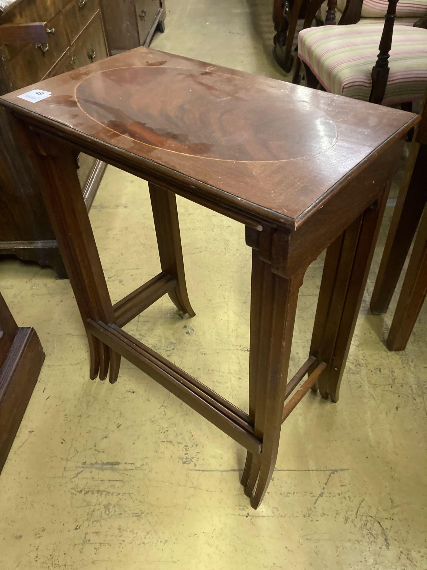 A nest of three Edwardian inlaid mahogany occasional tables, width 54cm